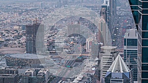 Skyscrapers on Sheikh Zayed Road and DIFC aerial day to night timelapse in Dubai, UAE.