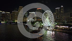Skyviews Miami Observation Wheel at Bayside Marketplace with reflections in Biscayne Bay and high illuminated