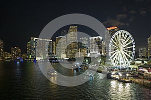 Skyviews Miami Observation Wheel at Bayside Marketplace with reflections in Biscayne Bay water and high illuminated