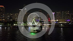 Skyviews Miami Observation Wheel at Bayside Marketplace with reflections in Biscayne Bay water and high illuminated