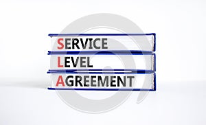 SLA service level agreement symbol. Concept words SLA service level agreement on beautiful books. Beautiful white background.