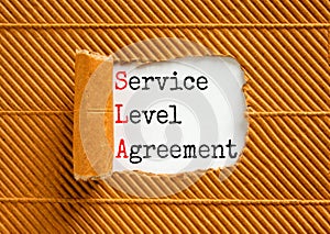 SLA service level agreement symbol. Concept words SLA service level agreement on beautiful white paper. Beautiful brown paper