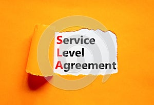 SLA service level agreement symbol. Concept words SLA service level agreement on beautiful white paper. Beautiful orange paper