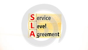 SLA service level agreement symbol. Concept words SLA service level agreement on beautiful wooden blocks. Beautiful white