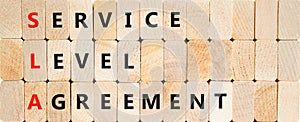 SLA service level agreement symbol. Concept words SLA service level agreement on beautiful wooden blocks. Beautiful wooden block
