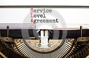 SLA service level agreement symbol. Concept words SLA service level agreement typed on beautiful retro typewriter. Beautiful white