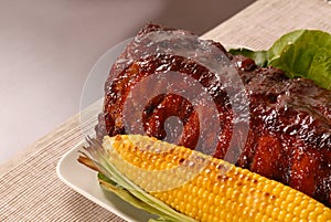 Slab of barbeque ribs and corn