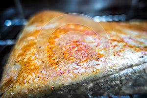 Slab of brisket meat in an electric bbq smoker