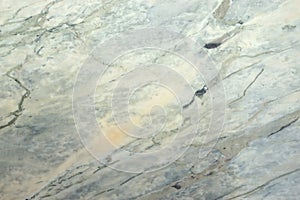 A slab of natural stone of a gray-pink color is called photo