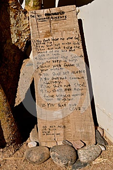 Slab of wood with printing of the 10 Commandments