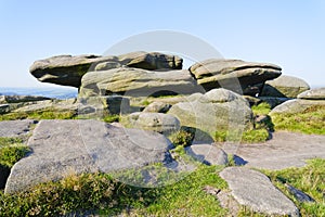 Slabs of gritstone perched on top of Stanage Edge photo