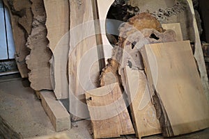 Slabs of raw timber stand, poised for transformation. The upcycling movement finds beauty in such unrefined materials.