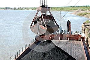 Slackline cableway bucket with coal at river port photo