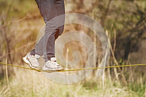 Slacklining is a practice of balancing, in which nylon or polyester fabric stretched between two anchor points is