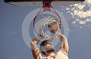 slam dunk in motion. summer activity. jumping man with basketball ball on court.