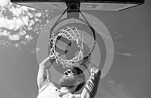 slam dunk in motion. summer activity. jumping man with basketball ball on court.