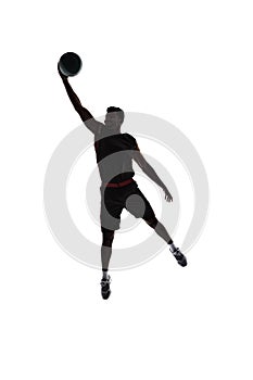 Slam dunk. Silhouette of basketball player in motion during game throwing ball in a jump isolated on white background