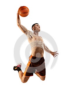 Slam dunk. Young muscled man, basketball player training with basketball ball isolated over white background. Sport