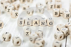 Slang word written on wood block. photo