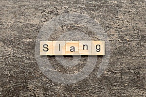 slang word written on wood block. slang text on table, concept