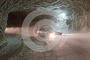 Car driving on an access tunnel