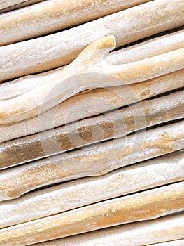 Slanted Rows of driftwood bunched together. Wooden twigs background