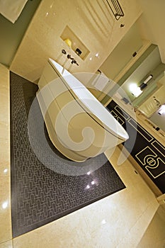 Slanted View of Classic design bathroom with bathtub, marble wall and versace inspired cabinet door