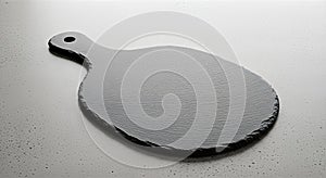 Slate cheese board with handle on a dark surface