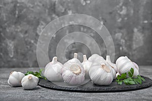 Slate plate with fresh garlic bulbs