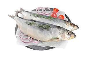 Slate plate with salted herrings, onion rings, dill and cherry tomatoes isolated on white