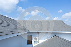 Slate roof against blue sky, Gray tile roof of construction house with blue sky and cloud