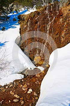 Slate stone texture and snow in Pyrenees Spain