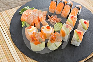 Slate tray of assorted sushi kept on mat
