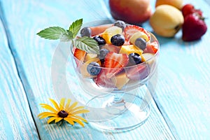 Slatky salad with a sprig of mint in the bowl of glass.