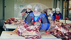 Slaughterhouse workers are dressing raw beef