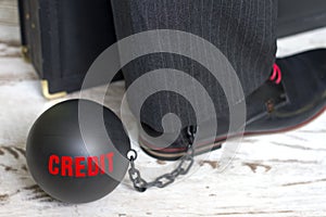 In slavery of credit concept with metal ball on chain and leg