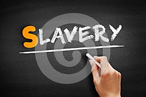 Slavery text on blackboard photo