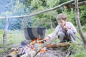 Slavic child in national clothes near the fire. photo