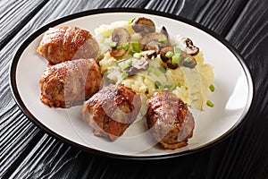 Slavink is ground meat, wrapped in bacon and fried in butter and lard served with mashed potatoes and mushrooms closeup in the