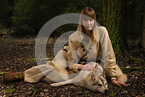 Slavonian girl and siberian husky in the deep forest