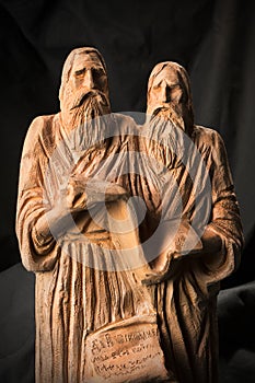 Slavonic educators Cyril and Methodius clay statues close up image. Old men hold scroll of holy scriptures. Russian alphabet make