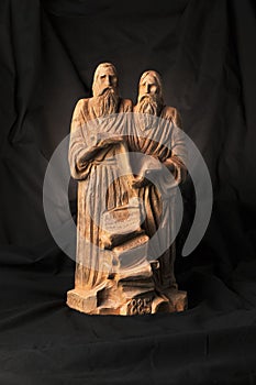 Slavonic educators Cyril and Methodius clay statues close up image. Old men hold scroll of holy scriptures. Russian alphabet make