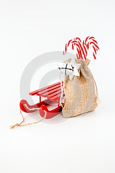 Sledge and Candy Canes in Jute Sack isolated on White