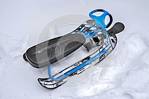 A sledge is in the snow, a close-up. A winter snowmobile
