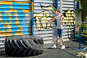 Sledgehammer Tire Hits men with hammer and tractor tire