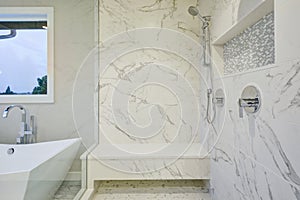 Sleek bathroom features marble walk-in shower photo