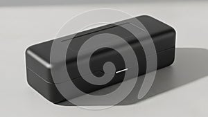 Sleek Black Rectangular Tech Device on a Clean White Surface