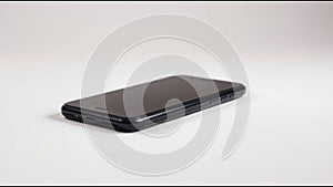 Sleek Black Smartphone on White Surface generated