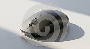 A sleek, black wireless computer mouse is placed on a gray surface, partially