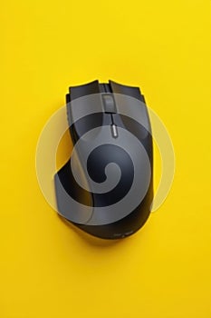Sleek black wireless mouse, vibrant yellow backdrop , bright, bluetooth
